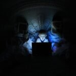 Child illuminated by a laptop's blue light in a dark room, conveying how online gambling addiction is rising.
